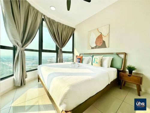 a bedroom with a large bed with a large window at Macrolink Medini @ UHA in Nusajaya