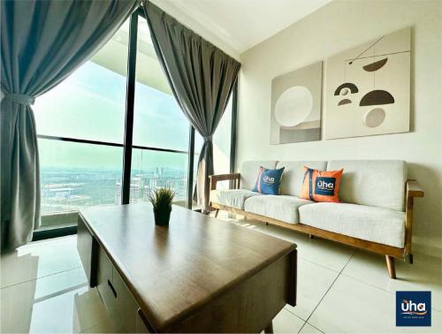 a living room with a couch and a large window at Macrolink Medini by RR JBcity in Nusajaya