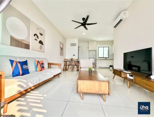 a living room with a couch and a flat screen tv at Macrolink Medini by RR JBcity in Nusajaya