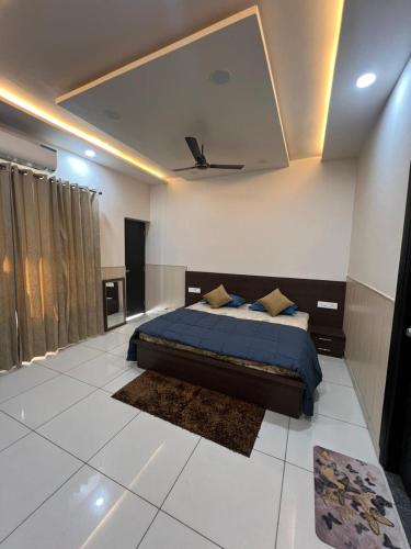 a bedroom with a bed with a blue comforter at Luxury 3bhk villa (mere bebe da villa)@gopal nagar in Jalandhar