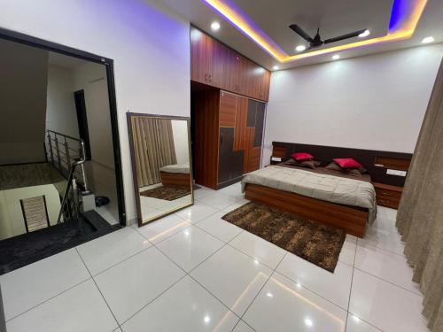 a bedroom with a bed and a mirror in it at Luxury 3bhk villa (mere bebe da villa)@gopal nagar in Jalandhar