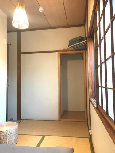 a room with a closet with a door at Guesthouse Hakuka in Kanazawa