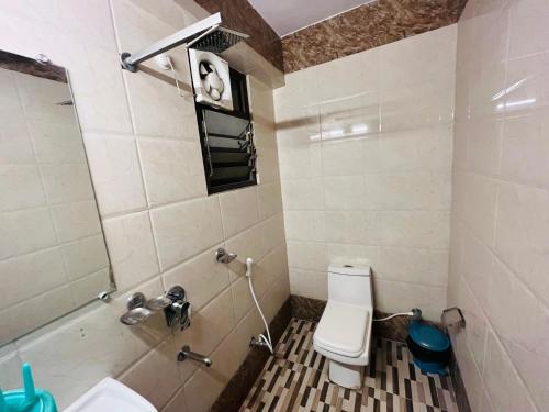 a bathroom with a toilet and a sink and a shower at Hotel Mani International in Patna