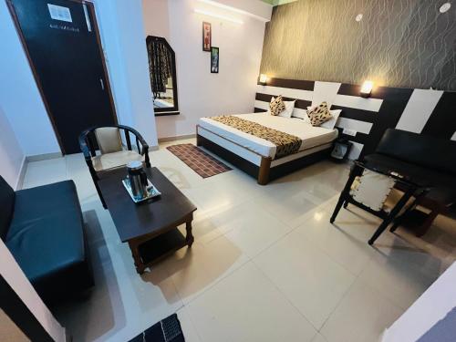 an aerial view of a bedroom with a bed and a table at Hotel Mani International in Patna