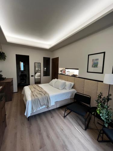 a bedroom with a large white bed and a desk at Retiro Studio in Madrid