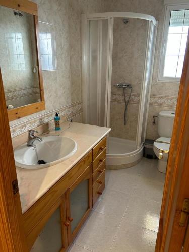 a bathroom with a sink and a shower and a toilet at Casa Aloe in Pulpí