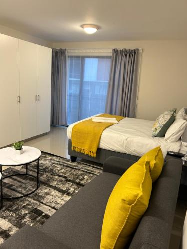 a bedroom with a large bed and a couch at Apartment in Umhlanga in Umhlanga
