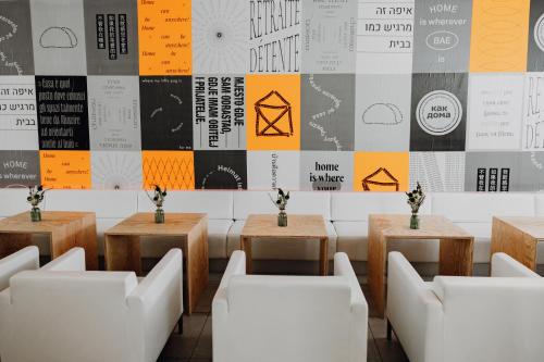 a room with tables and chairs and a wall with graphs at The Pure, Frankfurt, a Member of Design Hotels in Frankfurt/Main