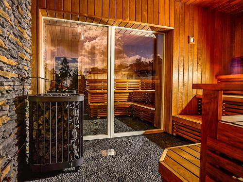 a room with a large glass door with a fireplace at Sudersand Resort in Fårö