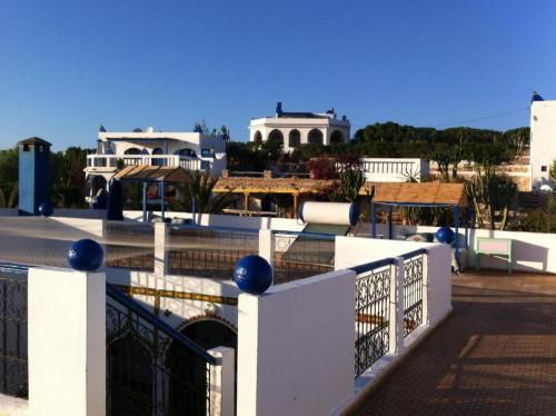 a white fence with blue balls on top of a building at Room in villa Lair De La Mer no0969 in Sidi Kaouki
