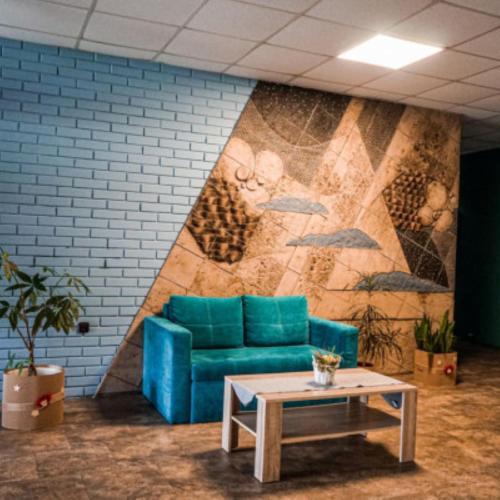 a living room with a blue couch and a table at Hotel Belaria Resort - wellness, bazén in Opava