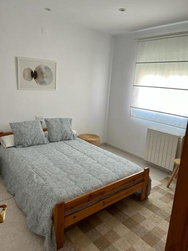 a bedroom with a large bed with a window at Casa Aloe in Pulpí