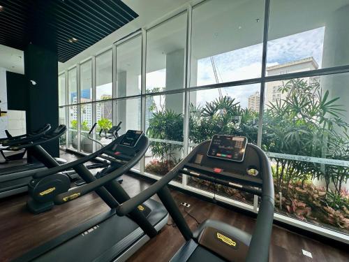a gym with two treadmills in a building at Heaven Cottage KLCC Suite in Kuala Lumpur