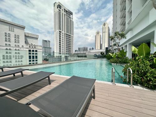 a swimming pool on the roof of a building at Heaven Cottage KLCC Suite in Kuala Lumpur