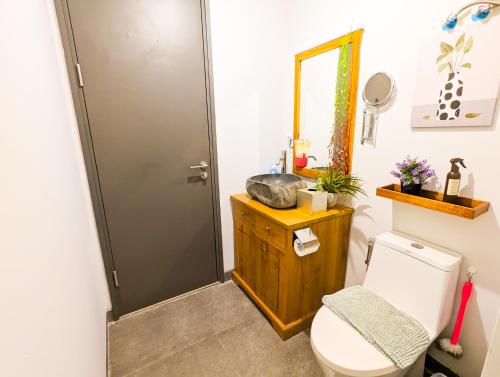 a bathroom with a toilet and a sink at Lovina 27-AB at One Residence(near Ferry & Megamall) in Batam Center