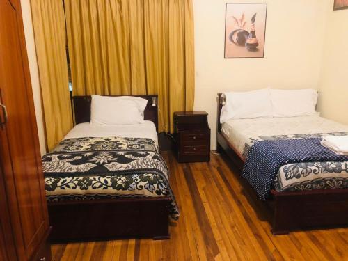 a small room with two beds and a window at CASA FRANCISCANA 1 in Quito