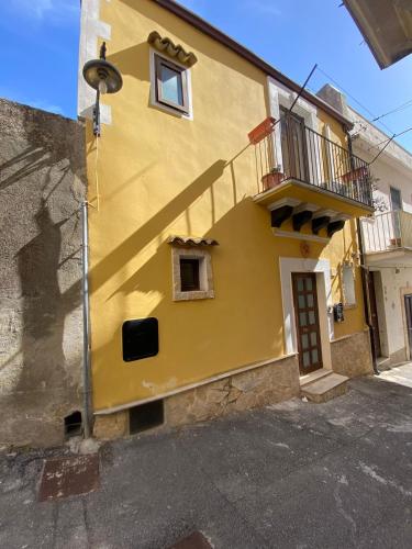 ein gelbes Gebäude mit einem Schatten auf der Seite in der Unterkunft Casa Arianna in Ragusa
