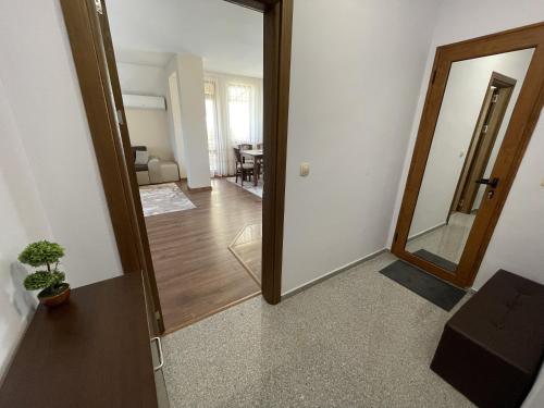 a hallway with a mirror and a dining room at Panorama view apartment in Sandanski