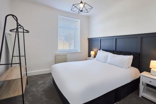 a bedroom with a large white bed and a window at Host & Stay - Spring Cottage in West Rainton