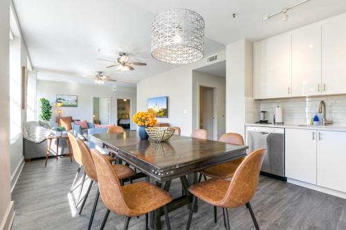 a kitchen and dining room with a table and chairs at Steps to French Quarter Rooftop & Gym Sleeps 12 in New Orleans