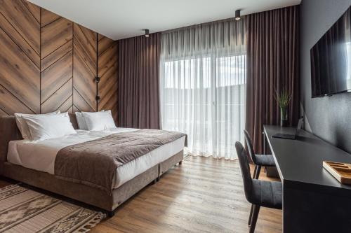 a hotel room with a bed and a desk and a desk at Didukh Eco Hotel&Spa in Bukovel