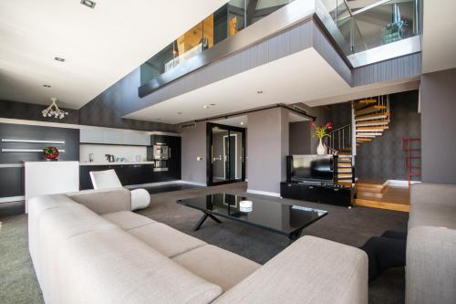 ein Wohnzimmer mit einer weißen Couch und einer Treppe in der Unterkunft Vernazza Suites in Istanbul