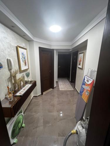 a hallway of a bathroom with a sink and a mirror at luxury flat with garden and private entrance شقة فاخرة بحديقة و مدخل خاص in Cairo