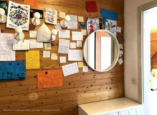 uma parede coberta de notas e um espelho em 71 square meters Condo in Schwarzwald with beautiful mountain view, free wifi em Schönwald