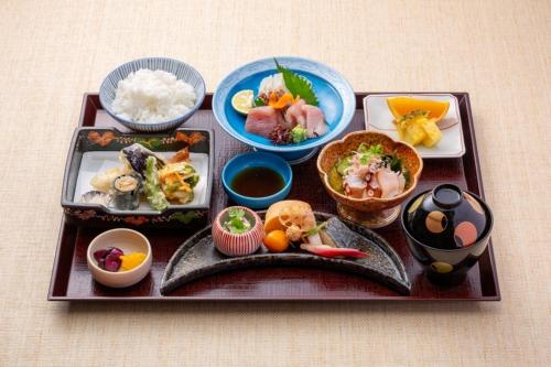 a tray with different types of food on it at Awa Kanko Hotel in Tokushima
