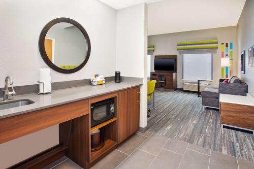 a hotel room with a sink and a mirror at Hampton Inn & Suites Tampa-East/Casino/Fairgrounds in Seffner