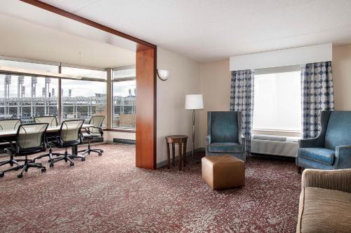 a waiting room with chairs and a table and a room with a balcony at Hilton Garden Inn Cleveland Downtown in Cleveland