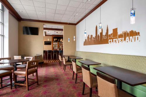 a dining room with tables and chairs and a wall at Hilton Garden Inn Cleveland Downtown in Cleveland