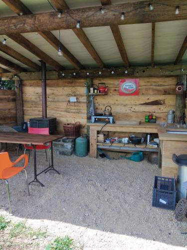 a wooden cabin with a table and chairs in it at Shirehill Farm, Shires Barns in Chippenham