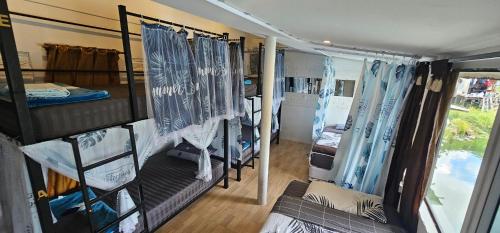 Zimmer mit einer Gruppe Etagenbetten in einem Wohnwagen in der Unterkunft Hideout Hostel in Haad Rin
