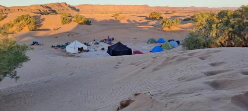 an aerial view of a camping site in the desert at Mhamid wild Trekking Camels in Mhamid