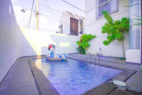 a swimming pool with a toy in the middle of a building at Villa Azzalia Syariah Private Pool and Karaoke in Tlekung
