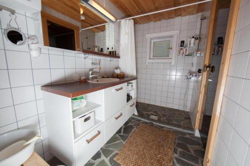 a bathroom with a sink and a toilet and a shower at Hukka, 4+3 hlö, Levi in Levi