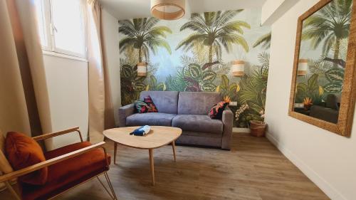 a living room with a couch and a table at Hotel Le M in Marseille