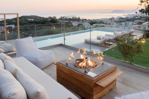 a living room with a fire pit on a patio at Centro Golden View Villa in Chania