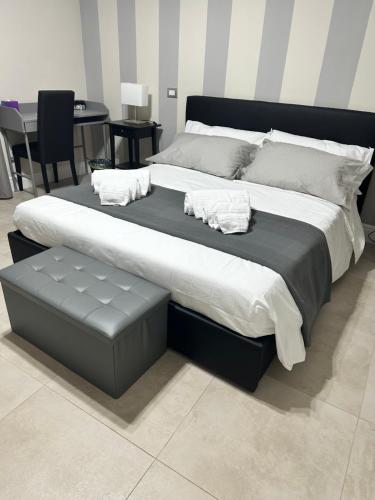 a large bed in a room with a table at La Finestra Sul Vulcano in Roccamonfina