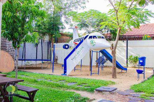 a small airplane on a slide in a yard at VILLA DE L'INTEGRATION in Ouagadougou