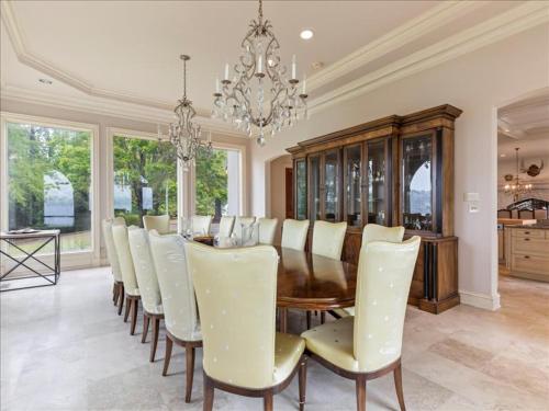 a dining room with a table and chairs and a chandelier at Lakeside Grande Villa in Alexander City