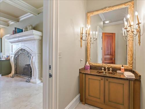 a bathroom with a sink and a mirror at Lakeside Grande Villa in Alexander City