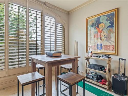 a table and two stools in a room with a painting at Lakeside Grande Villa in Alexander City