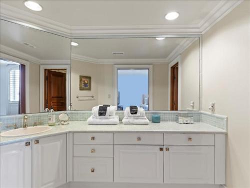 a bathroom with a sink and a large mirror at Lakeside Grande Villa in Alexander City