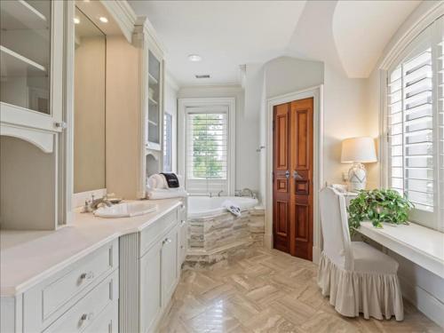 a white bathroom with a tub and a sink at Lakeside Grande Villa in Alexander City