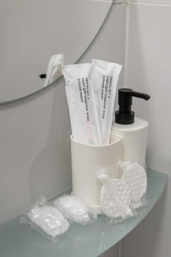a shelf with toothbrushes and other items on it at Апартаменти MYFREEDOM поруч із метро Бориспільська in Kyiv