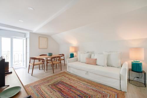 a living room with a white couch and a table at Renovated House Near Beaches, By TimeCooler in Setúbal