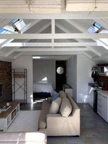 a living room with a couch and a bed at Myrtle Loft in Cape Town