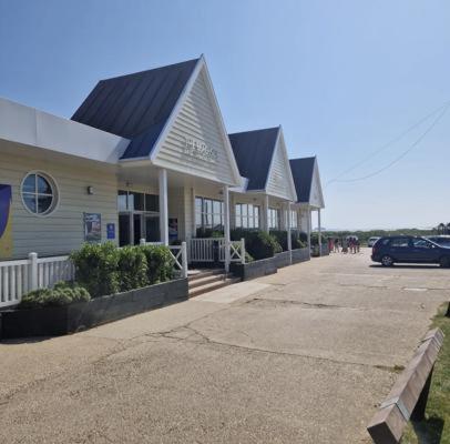 a row of houses with a car parked in front at Luxuary Static Caravan Sleeps 6 Coopers Beach - Luxurious Get Away in East Mersea